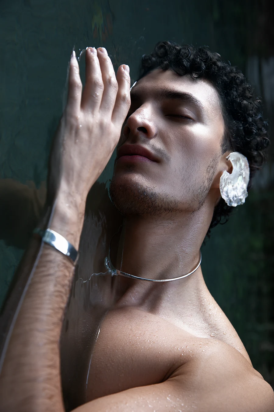 Luian wearing a mother-of-pearl ear ornament and SERGIO STUDIO jewellery in water at Tolantongo.